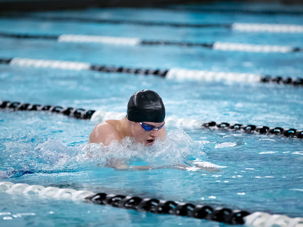 young man swimming the breaststroke